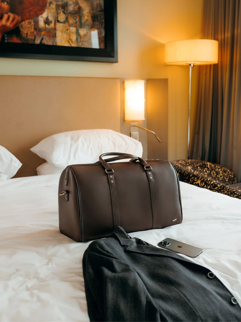 f34 duffle bag brown leather on bed