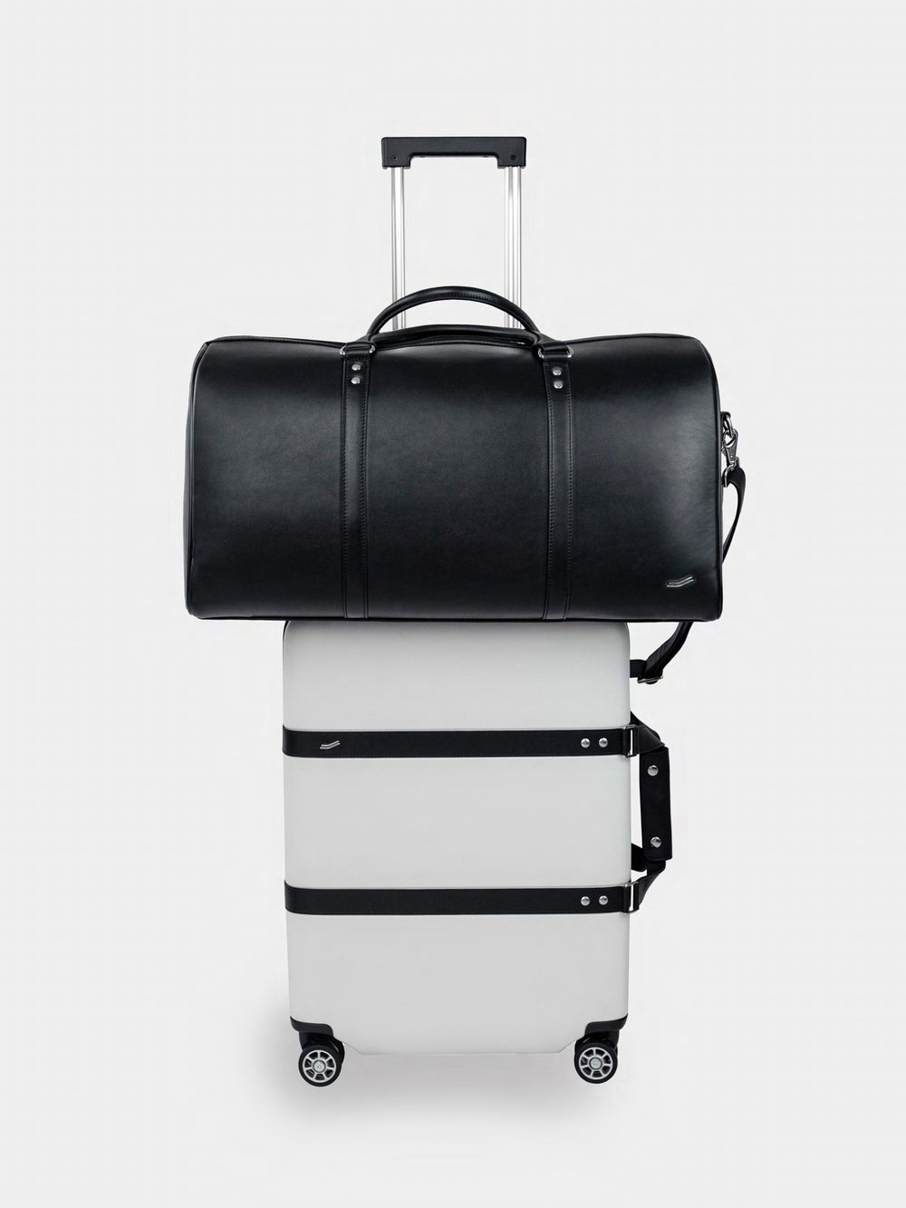 f36 duffel bag large leather black front paired with p55 carry on arctic white
