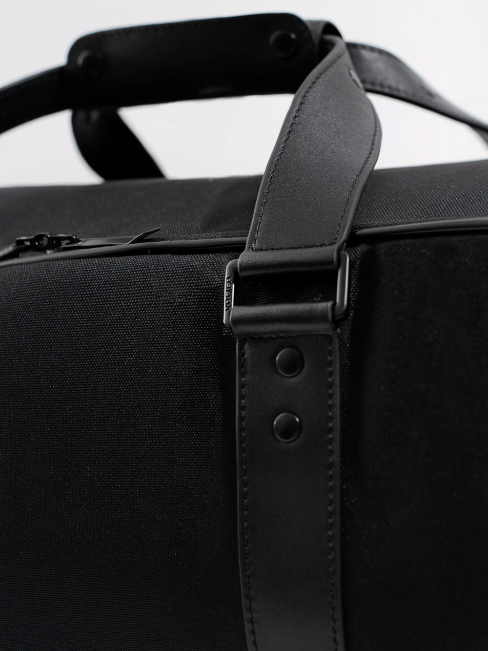 c35 garment bag detail of black nylon fabric and with leather details 