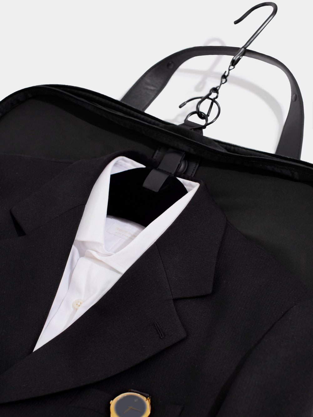 c35 garment bag in black nylon open with suit and shirt visible