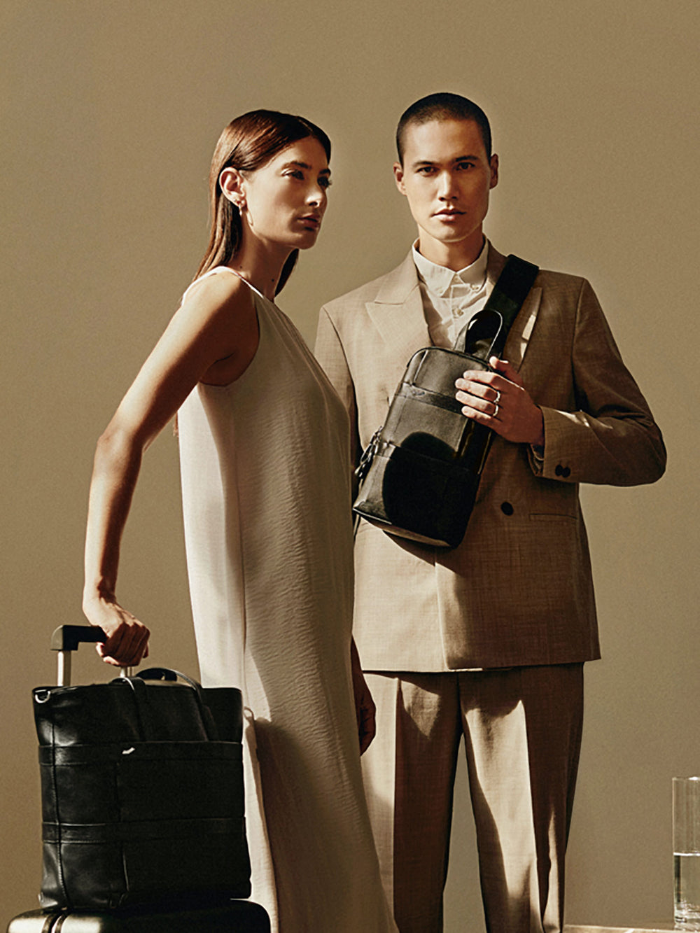 vocier vantage tote bag and sling bag on traveller suitcase woman and man